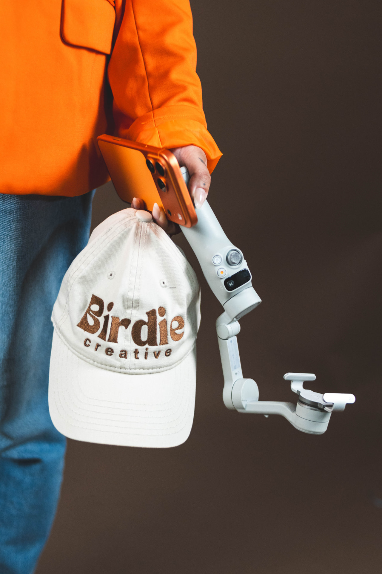 Birdie Creative cap held beside a phone and camera stabilizer